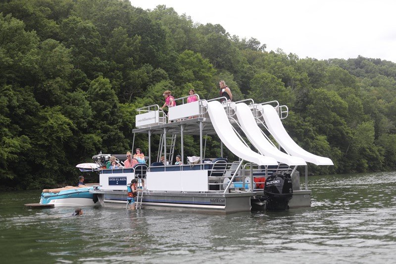 family having fun on the triple slide party boat from rowdy boats on piercy priest lake