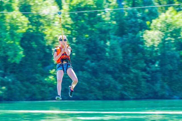 young child on a zipline over water