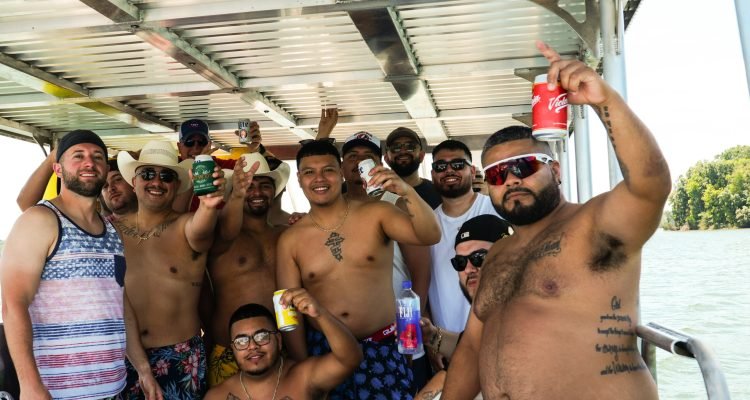 Guys celebrating bachelor party on a Rowdy Boat slide pontoon boat on Percy Priest Lake in Nashville